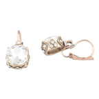 Rose gold earrings with clear gemstones on a white background