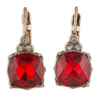 Pair of earrings with red gemstones and gold accents on a white background