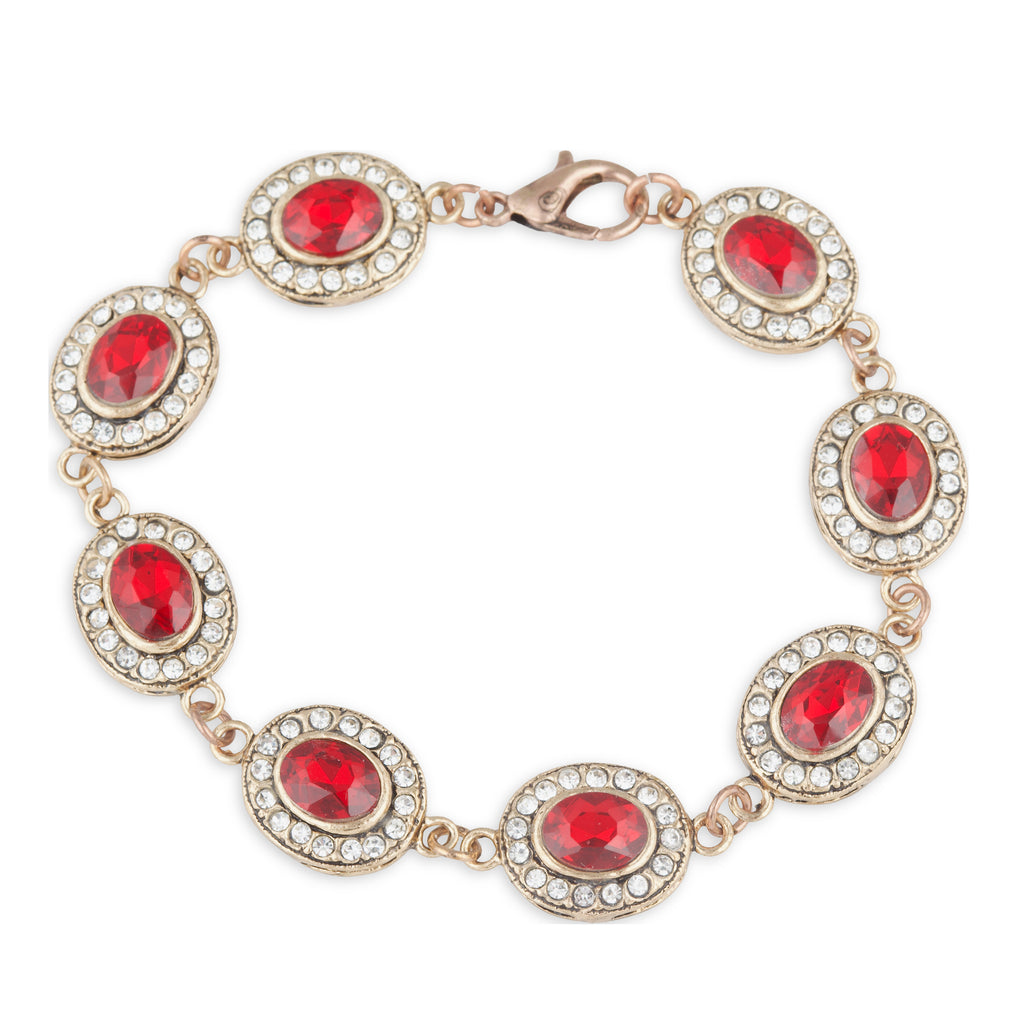 Gold bracelet with red gemstones on a white background