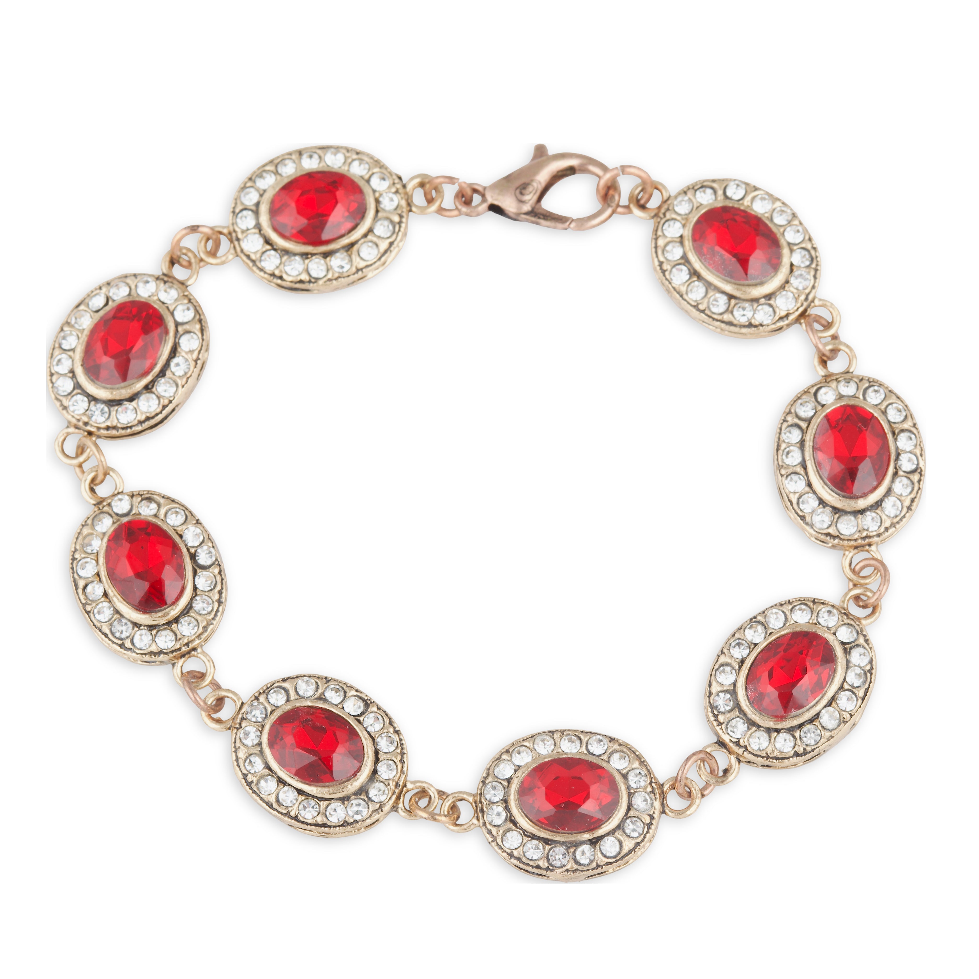 Gold bracelet with red gemstones on a white background